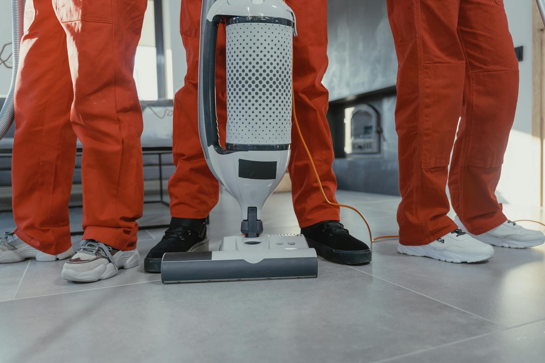 A team of professional Your Business cleaners in red uniforms using a vacuum in a New York home — Same-Day Cleaning in Ardsley, Westchester