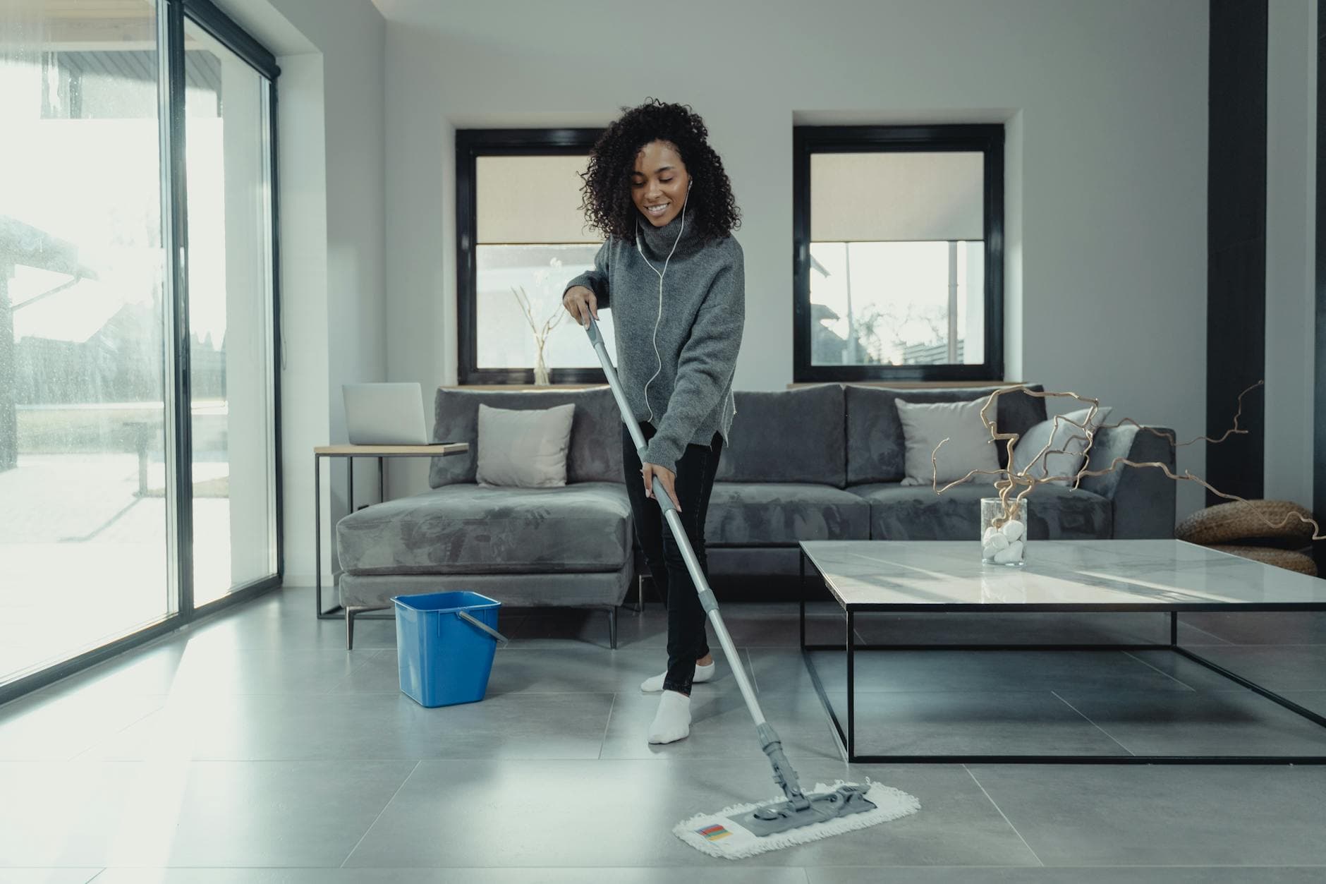 A maid from Your Business mopping a tiled floor in a cozy New York City apartment — Weekly Maid Service in Boerum Hill, Brooklyn